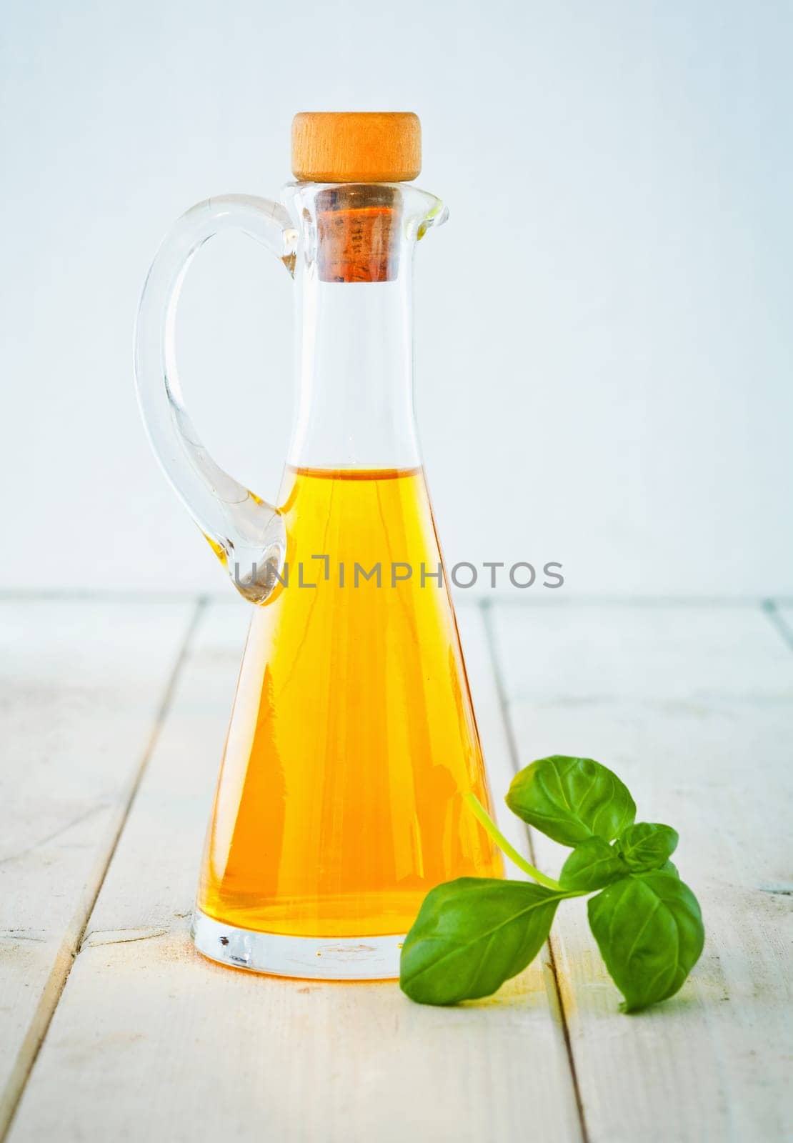 A conical bottle of cold-pressed extra-virgin olive oil for use as a salad dressing and in cooking, italian concept.