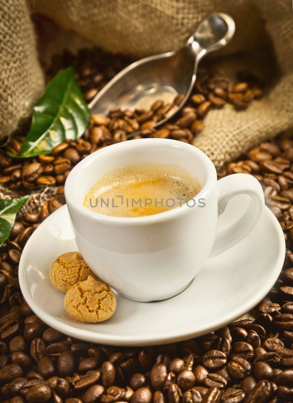 Espresso cup with fresh brewed coffee and beans