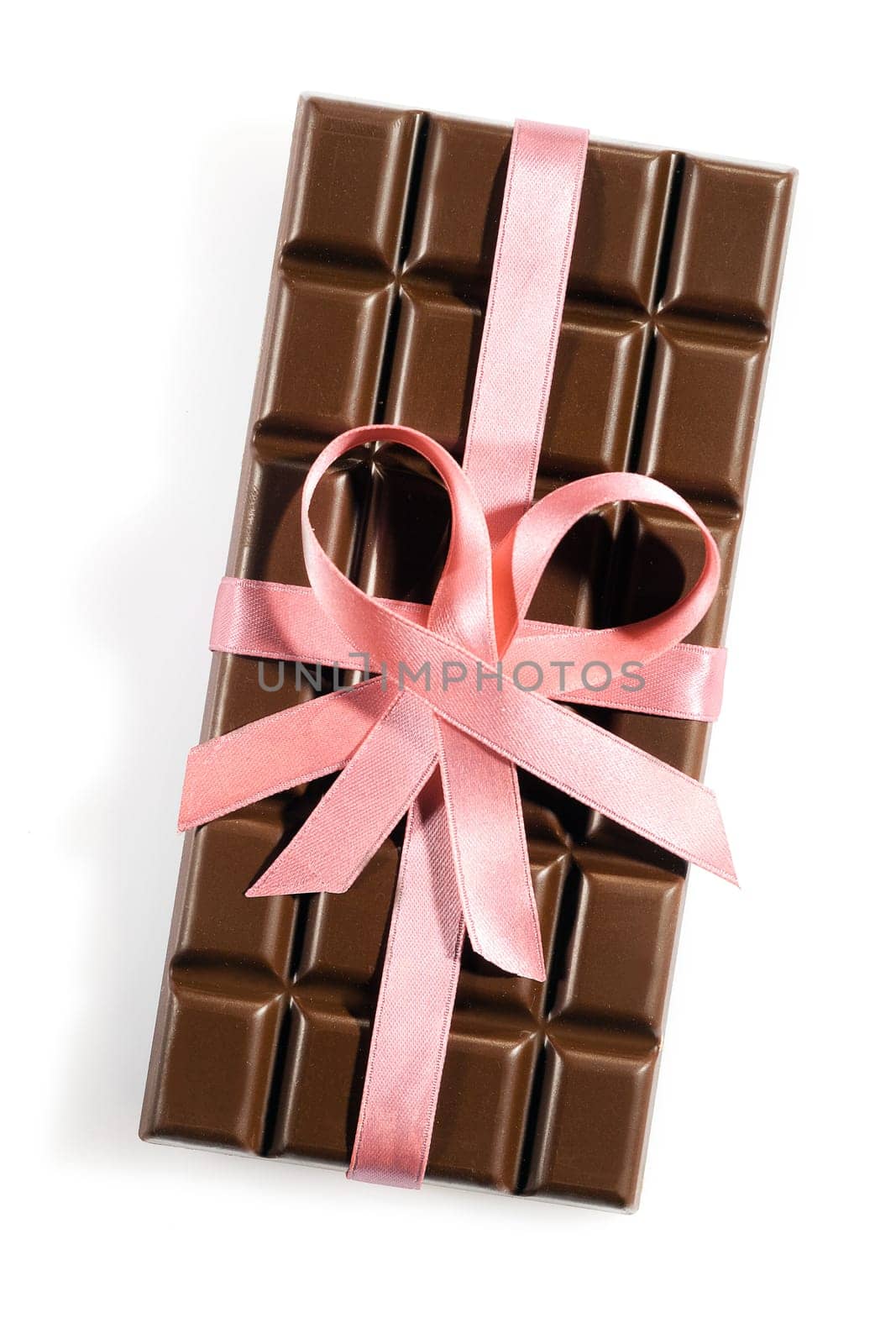 Chocolate bar with a rose or pink ribbon or bow isolated on white background