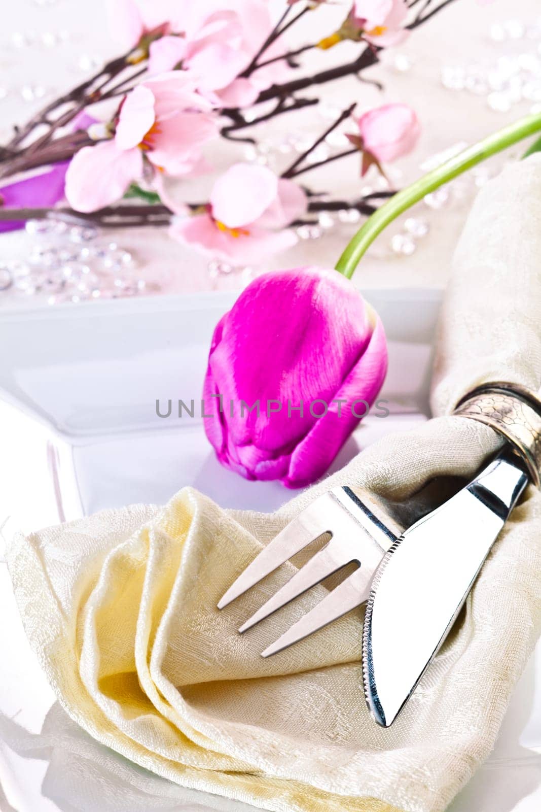 Spring Table setting with a tulip and a cherry blossom in the background