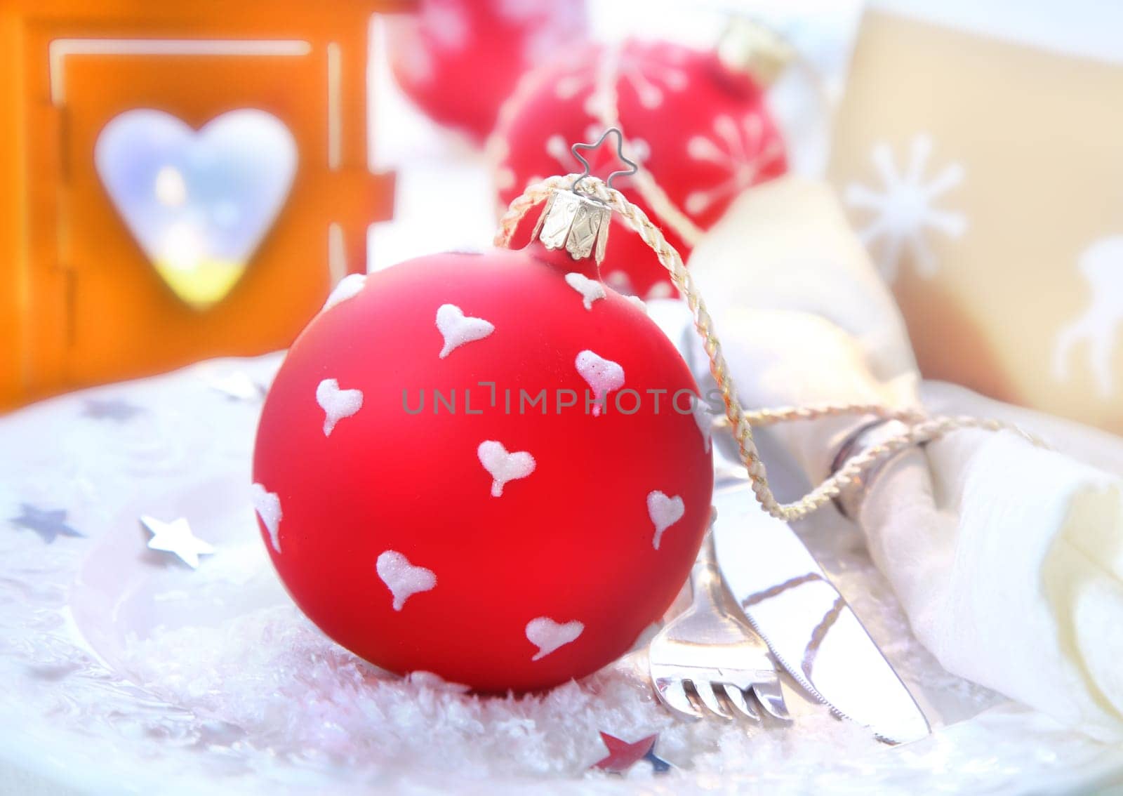 Red Christmas Bauble with a decorative heart-shaped christmas lantern and a festive table setting