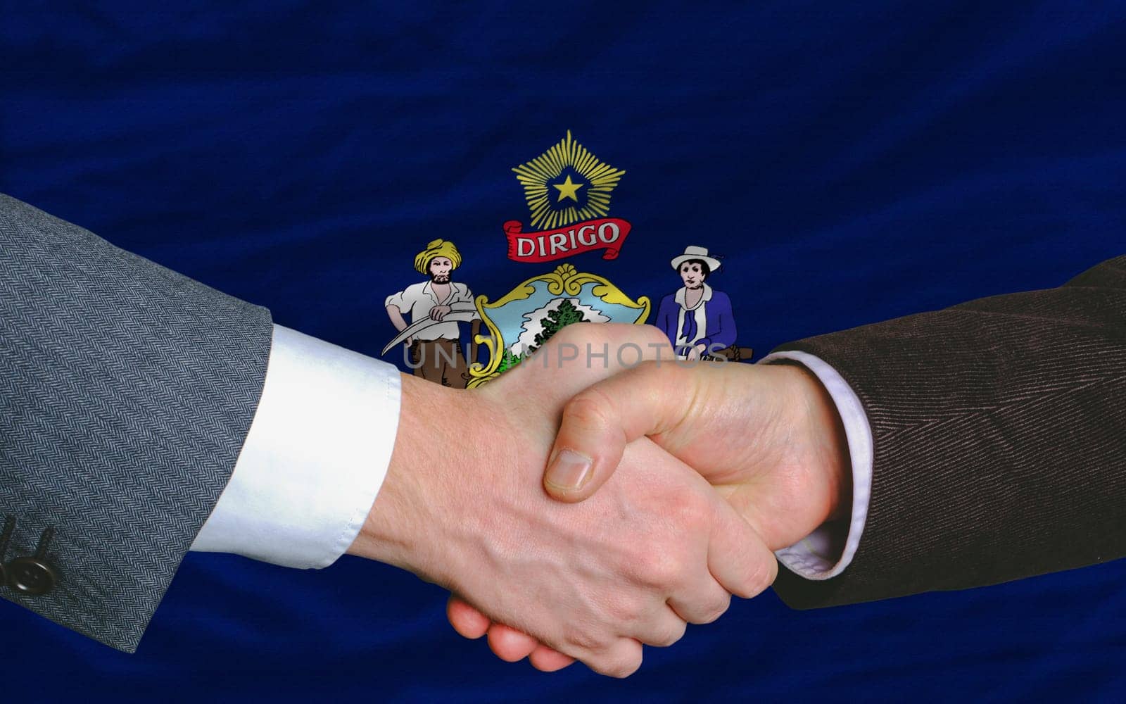 two businessmen shaking hands after good business investment  agreement in front US state flag of maine