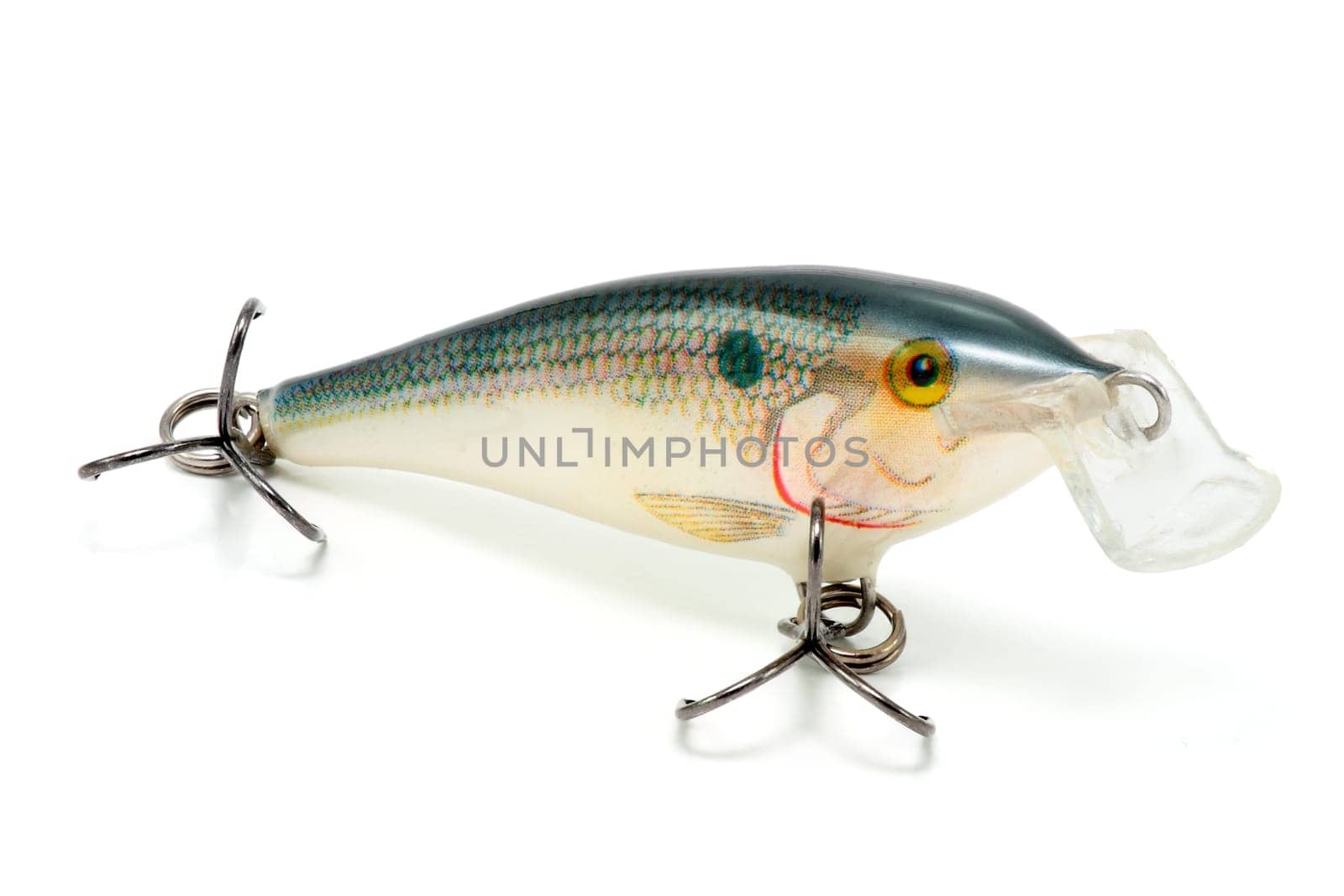 Artificial fish with hooks for fishing in depredaores surface flat on white background