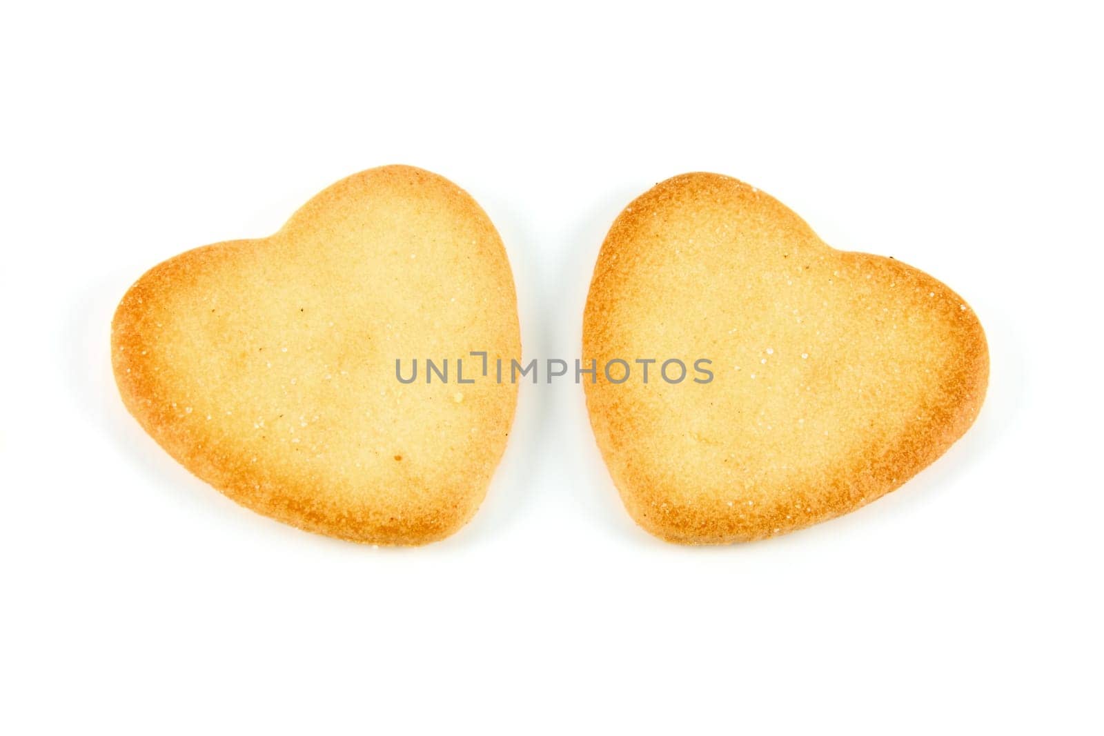 two heart shaped cookies made ​​with natural ingredients on white background