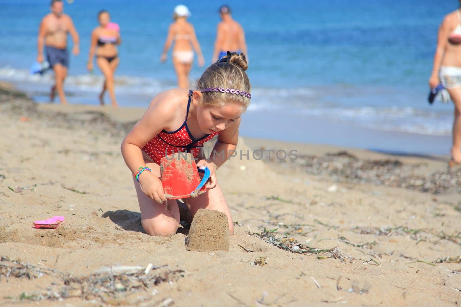 Kids playing with plastic toys on the beach