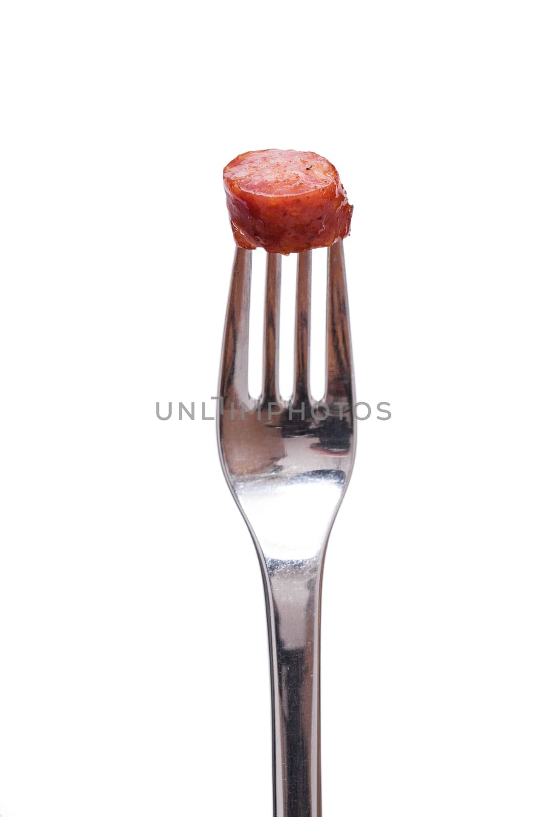 Sausage pepper biter and a fork against white background