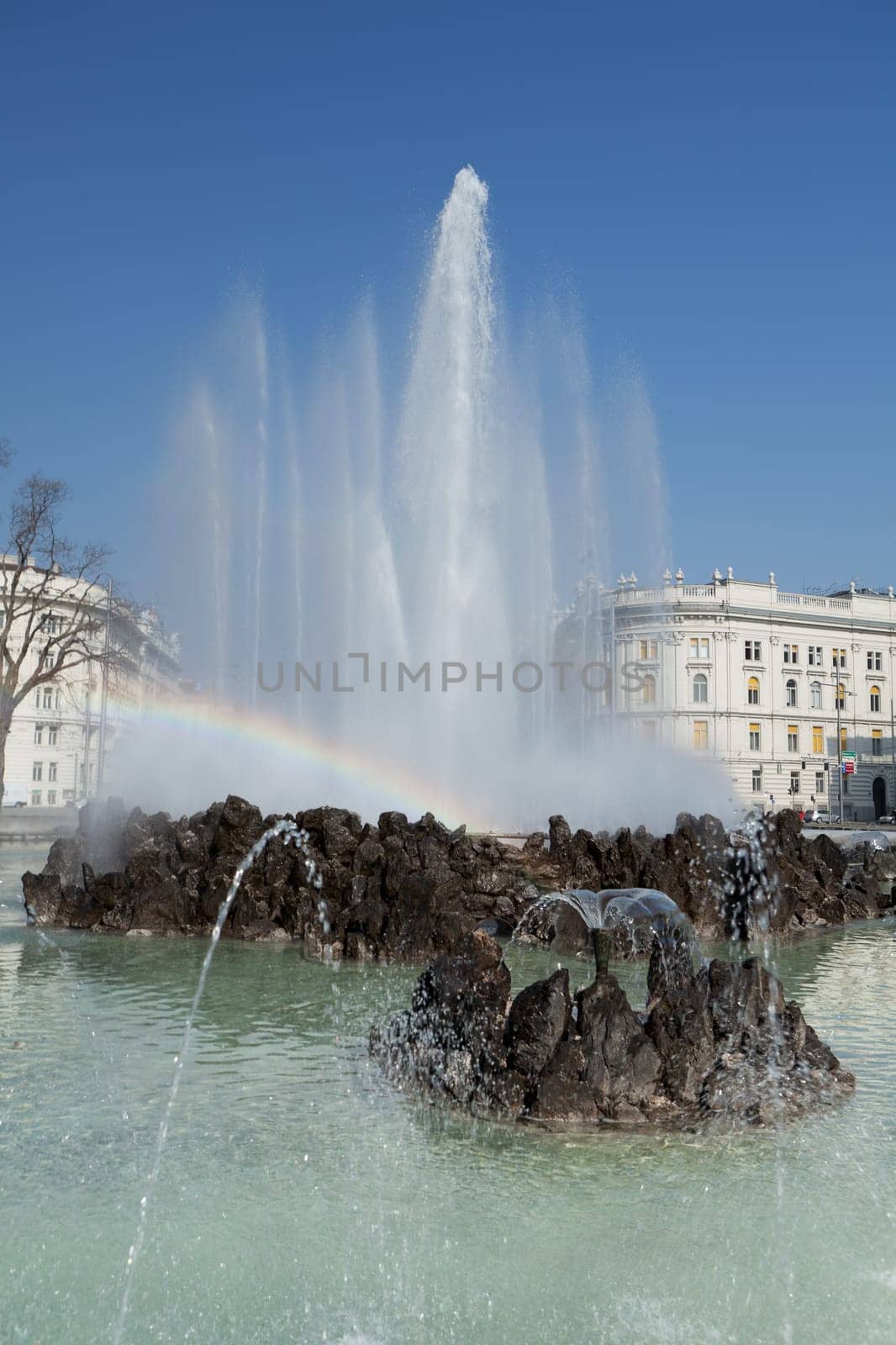 Hochstrahlbrunnen Schwarzenbergplatz,Vienna,in the center of the city with rainbow