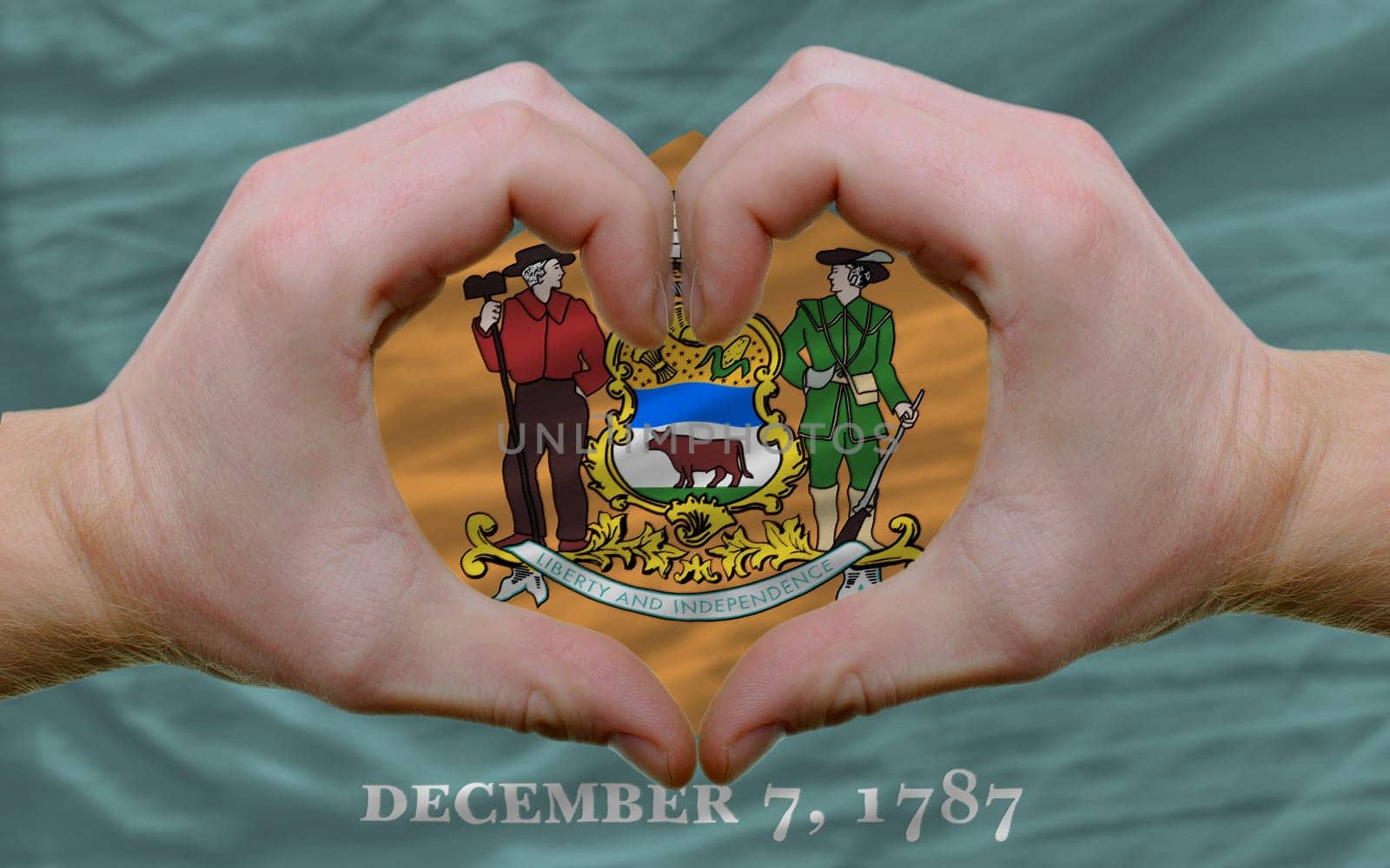 Gesture made by hands showing symbol of heart and love over us state flag of delaware