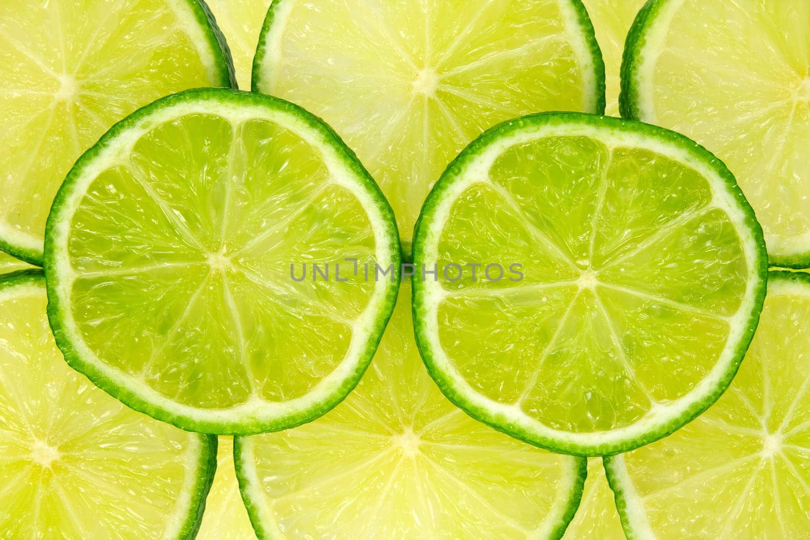 close-up image of fresh green lemon slices