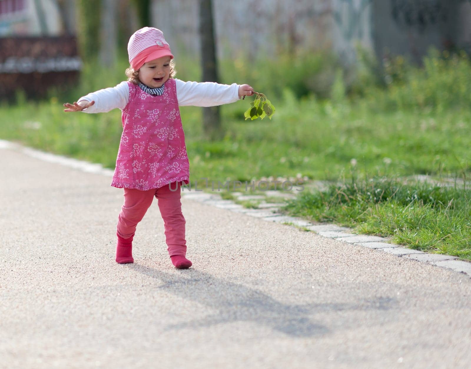 Toddler laughing with outstretched arms