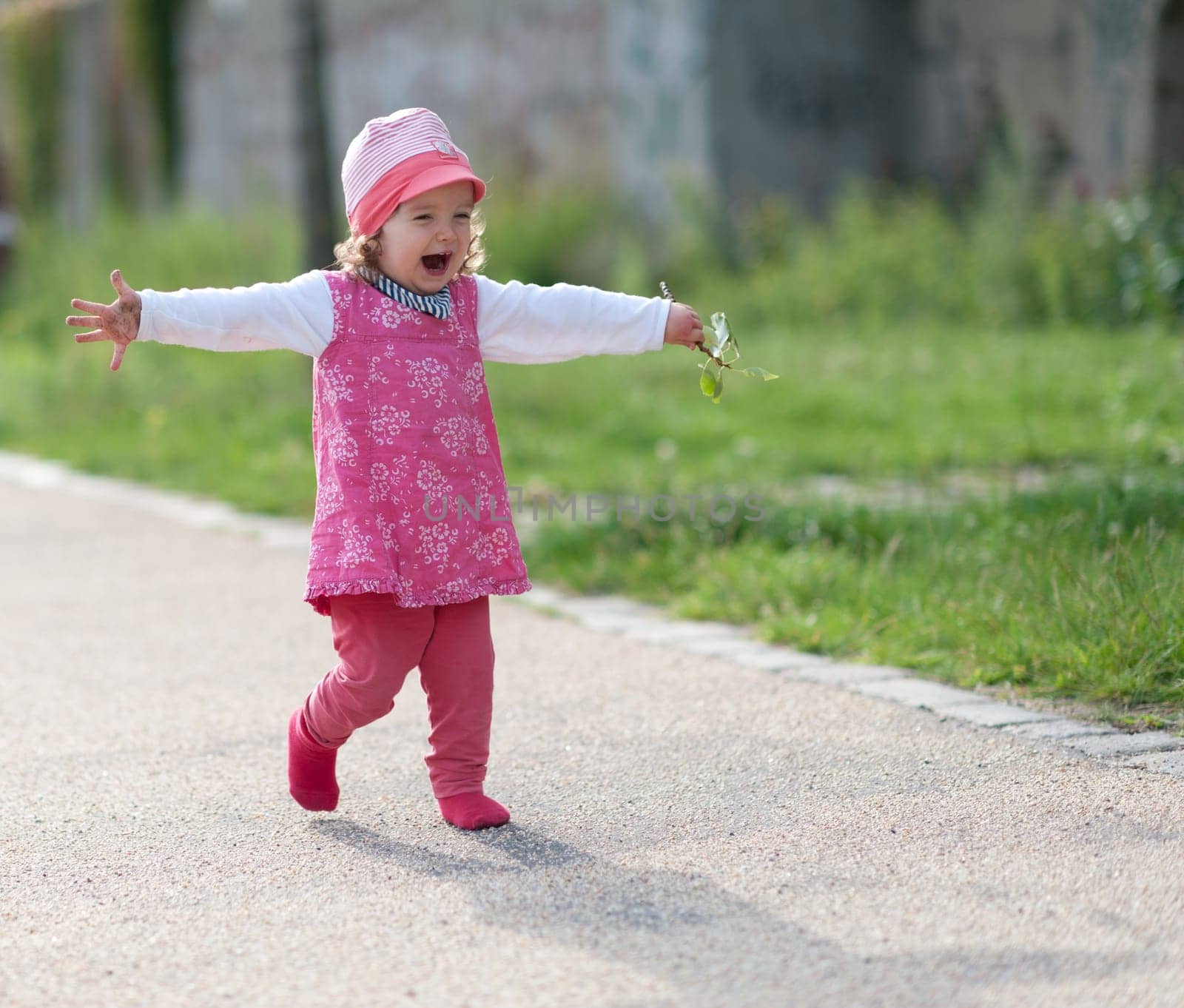 Toddler laughing with outstretched arms