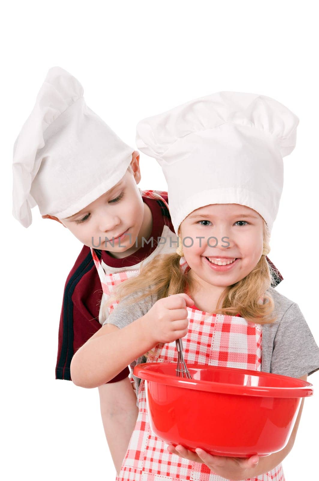 two children in chef&#039 s hat isolated on white background