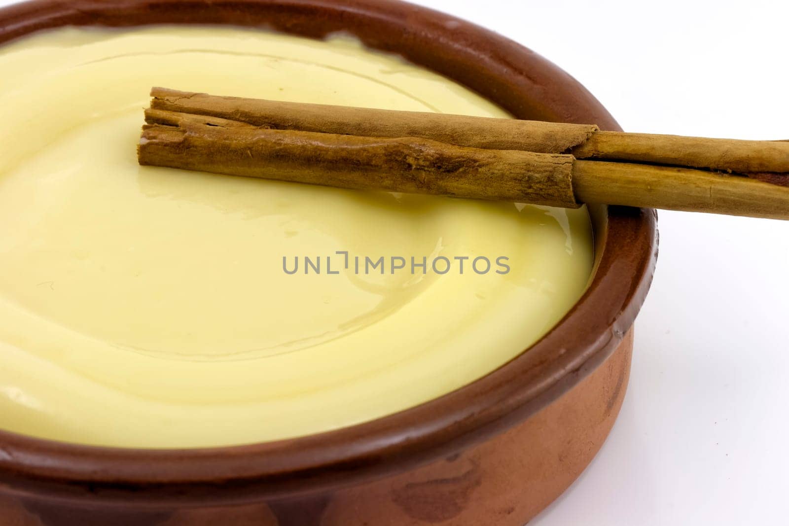 clay bowl, tasty dessert custard and cinnamon, detail