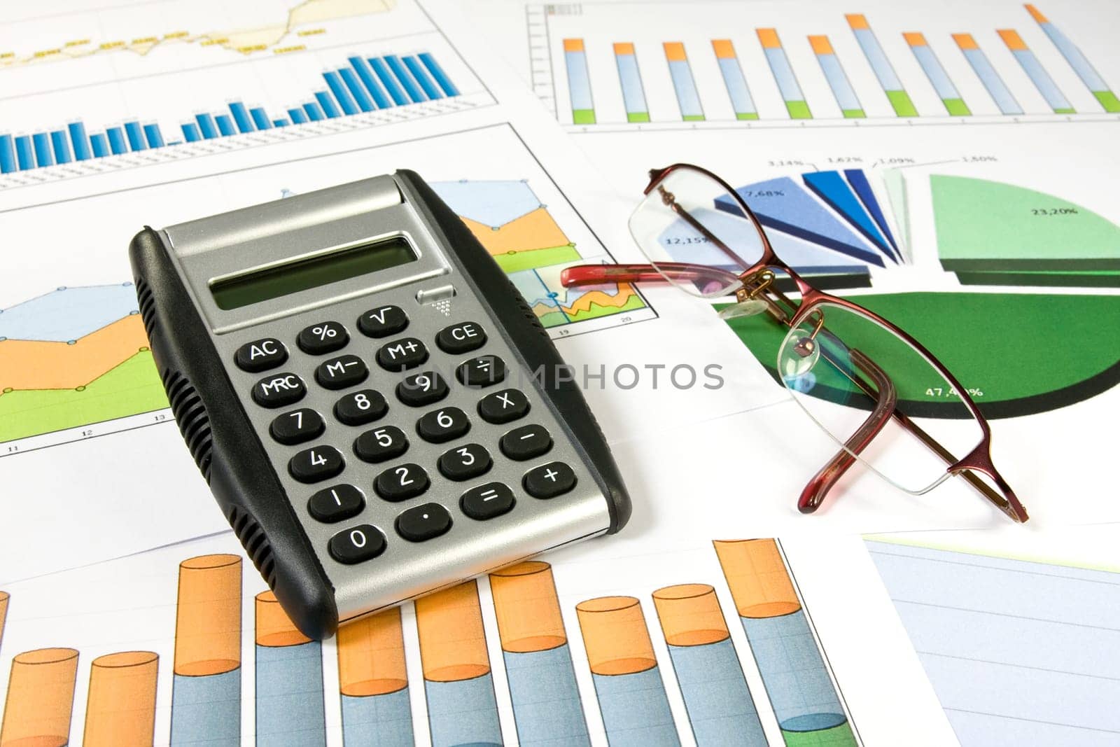 business concept. colorful  charts, calculator and glasses