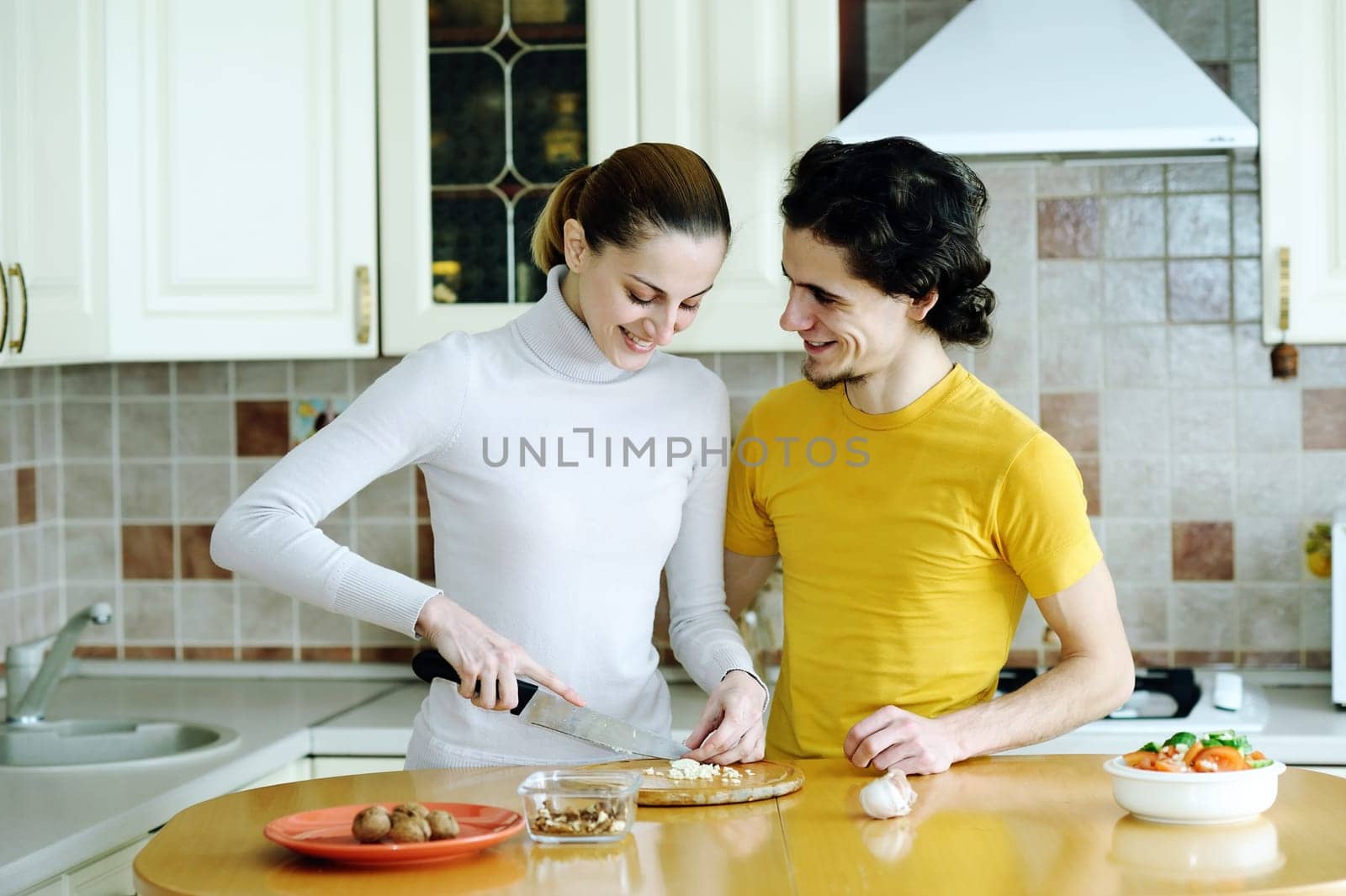 An image of couple in the kichen preparing vegetarian food