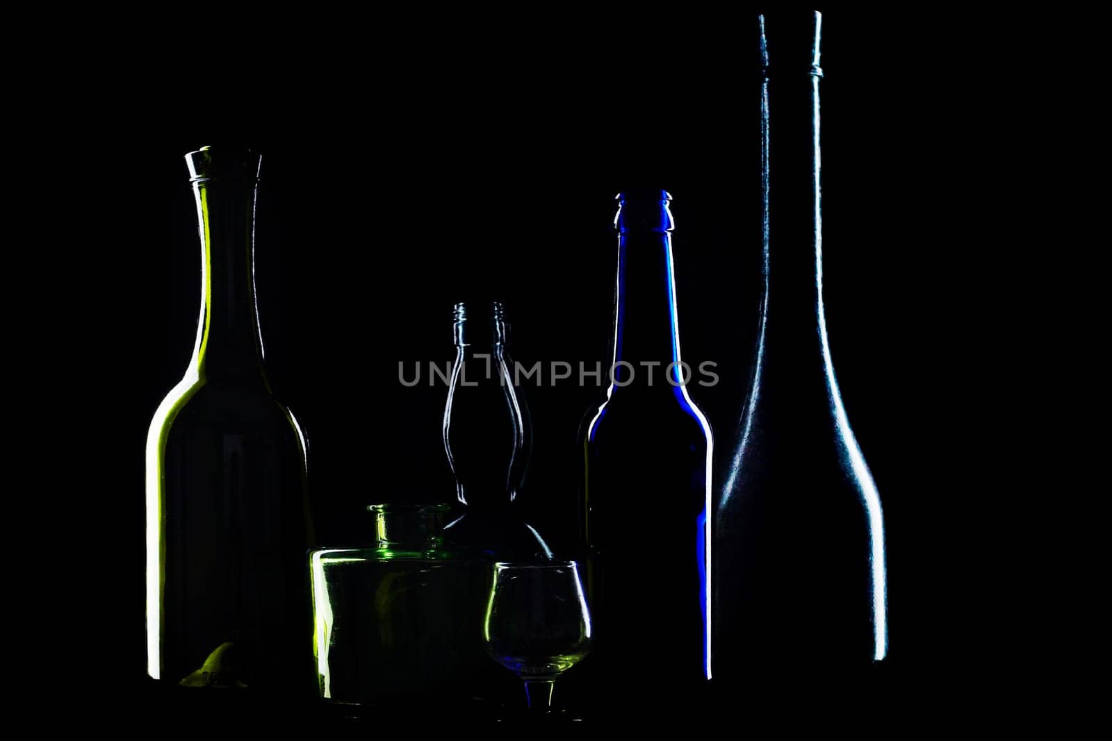 An image of silhouettes of bottles on black background