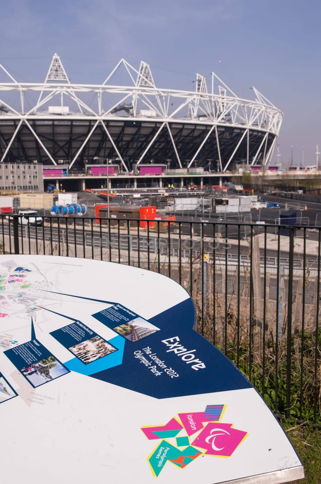 LONDON, UK – MARCH 24: Details of information board with London Olympics logo and Olympic Stadium in the background on March 24, 2012 in London. The Olympic Park is due to be ready in summer for the games.