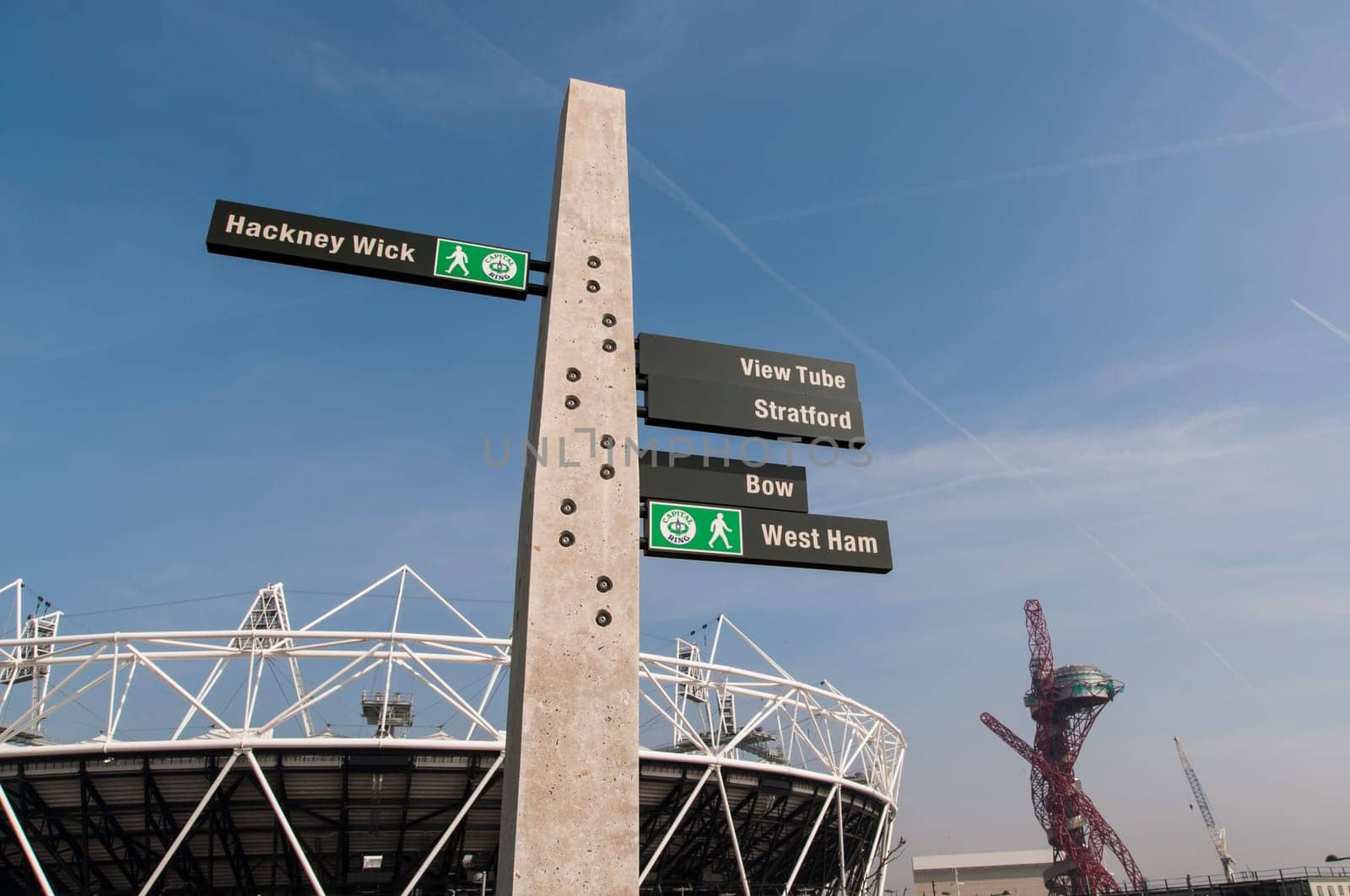 LONDON, UK – MARCH 24: Details of sign post with Olympic stadium in the background on March 24, 2012 in London. All locations around the Olympic Park are undergoing redevelopment works.