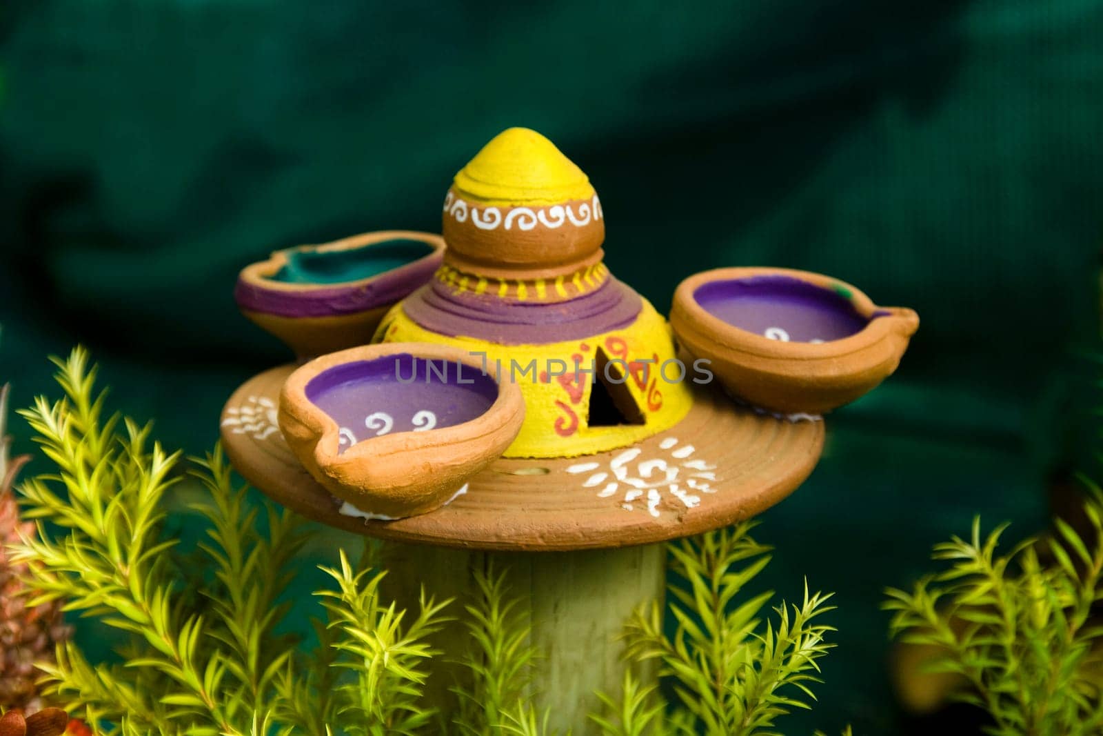 Three lamps and lamp stand made of red earth tastefully decorated with paint