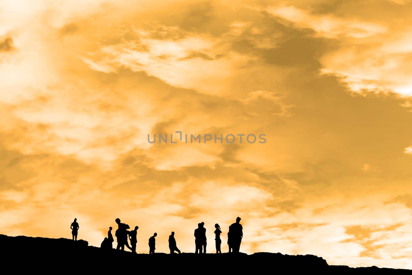 Silhouette of crowd of people on the peak edge of a cliff in ireland with clipping path