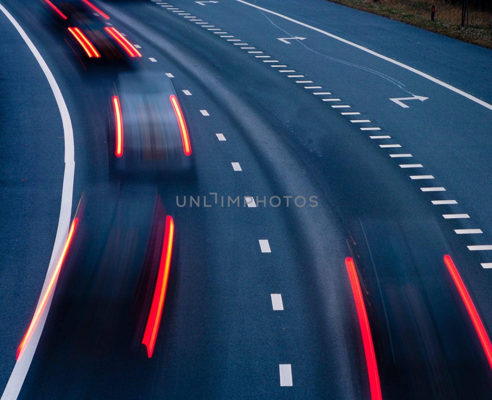 blurred lights of cars on a highway at evening