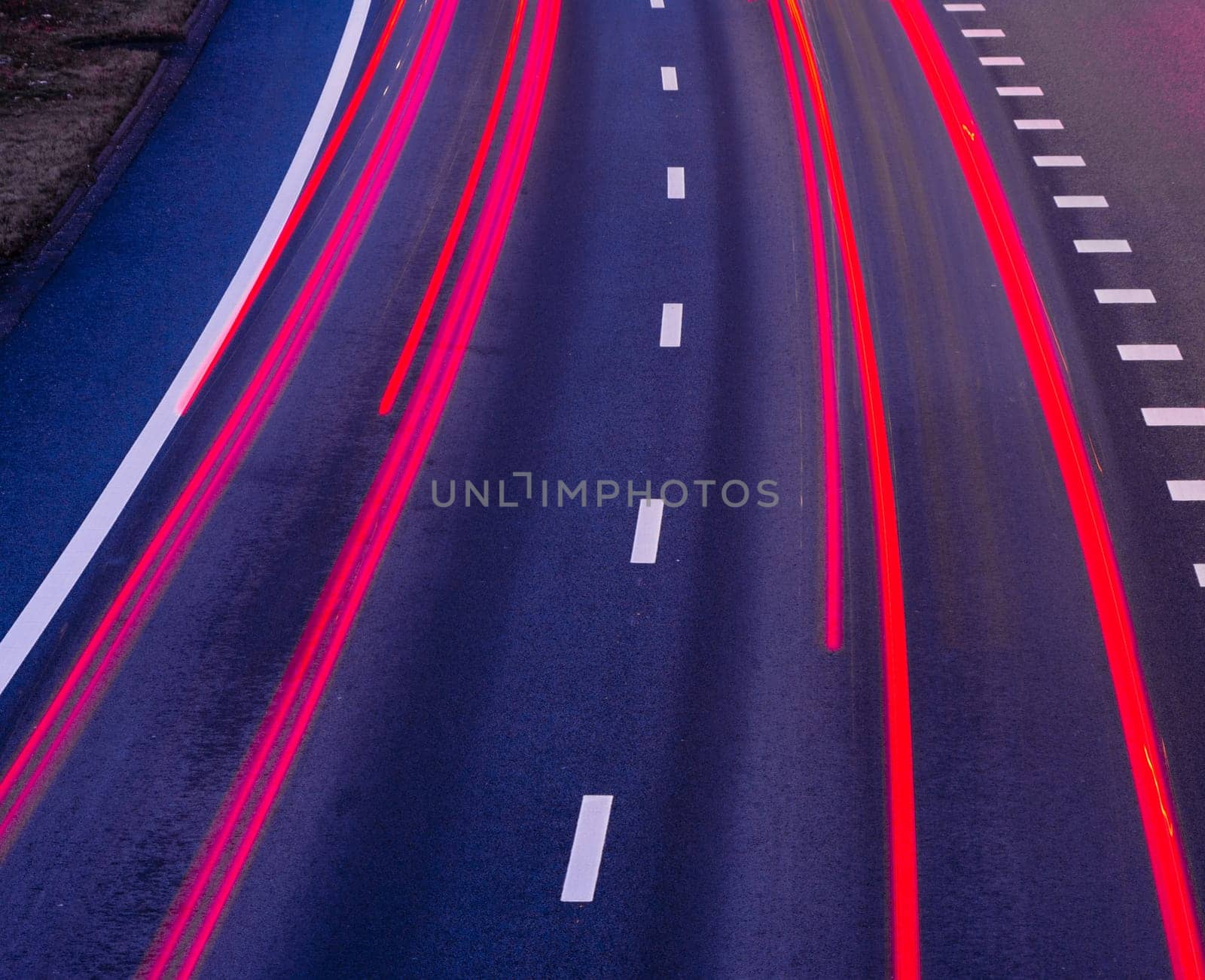 blurred lights of cars on a highway at evening