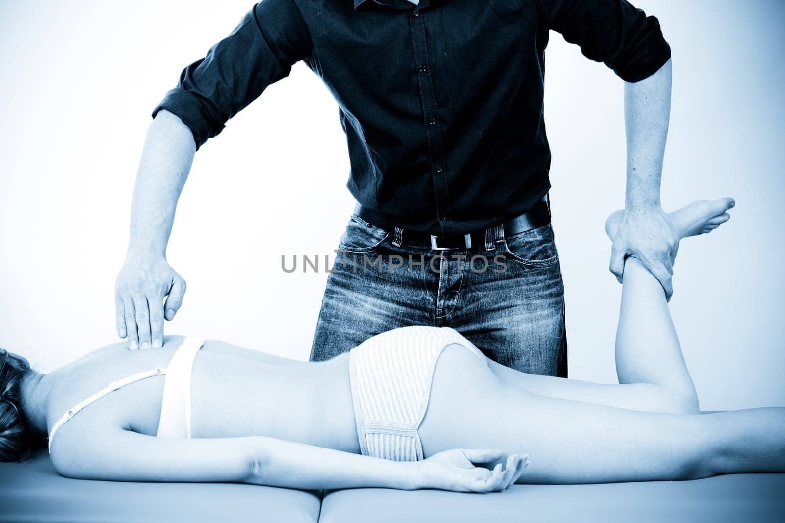 Massage therapist giving a massage. female receiving professional massage. pain concept.