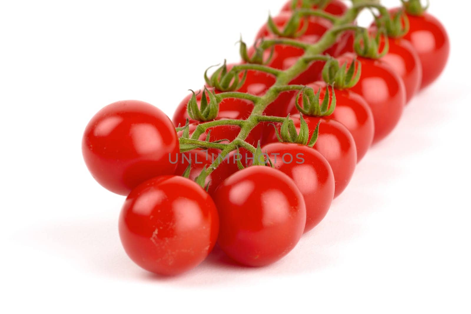 Cherry tomatoes isolated against white background