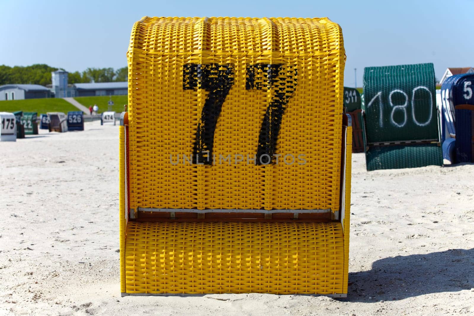 Yellow beach chair from behind on the beach of the Baltic Sea