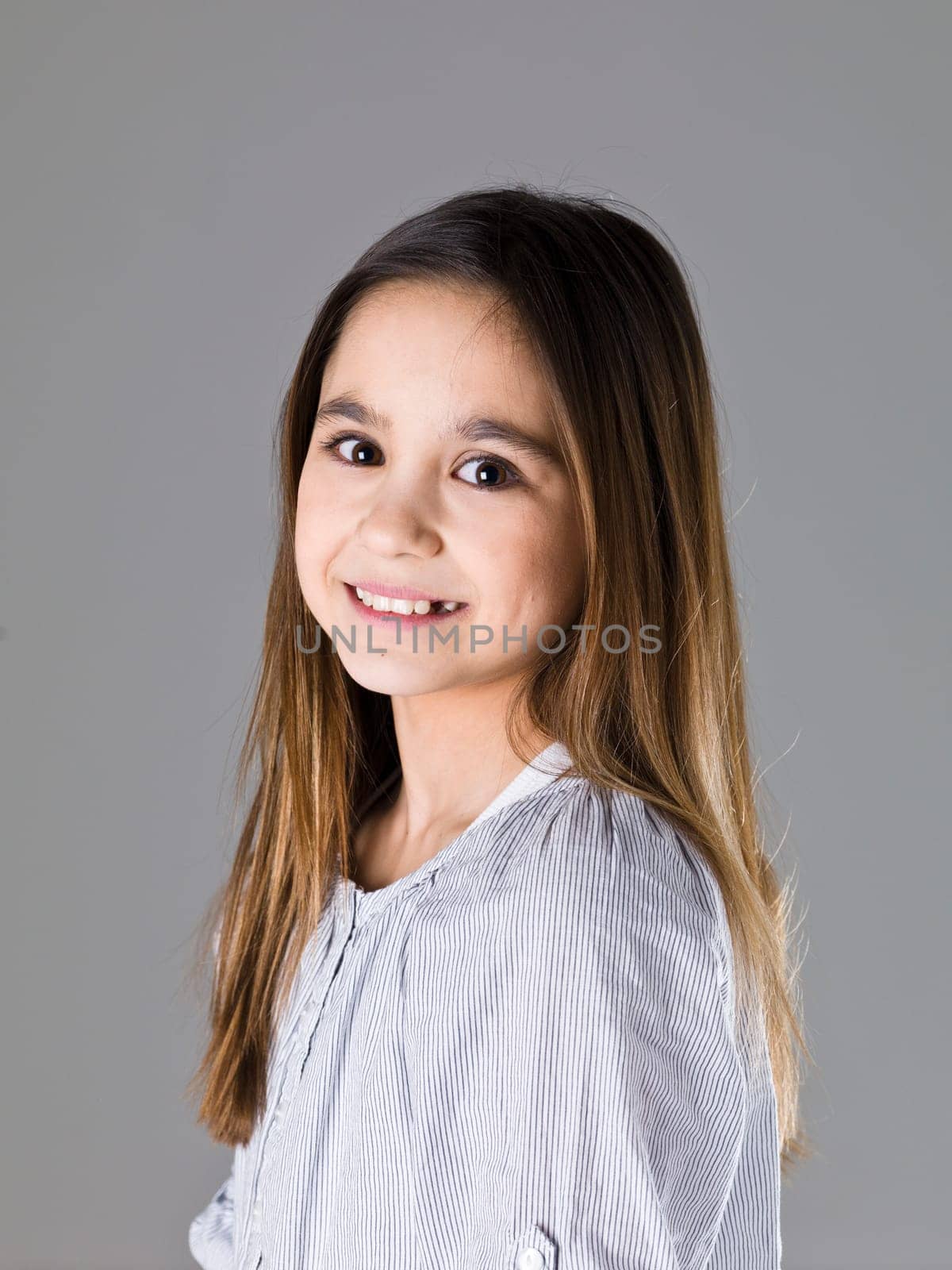 Portrait of a young girl on grey background