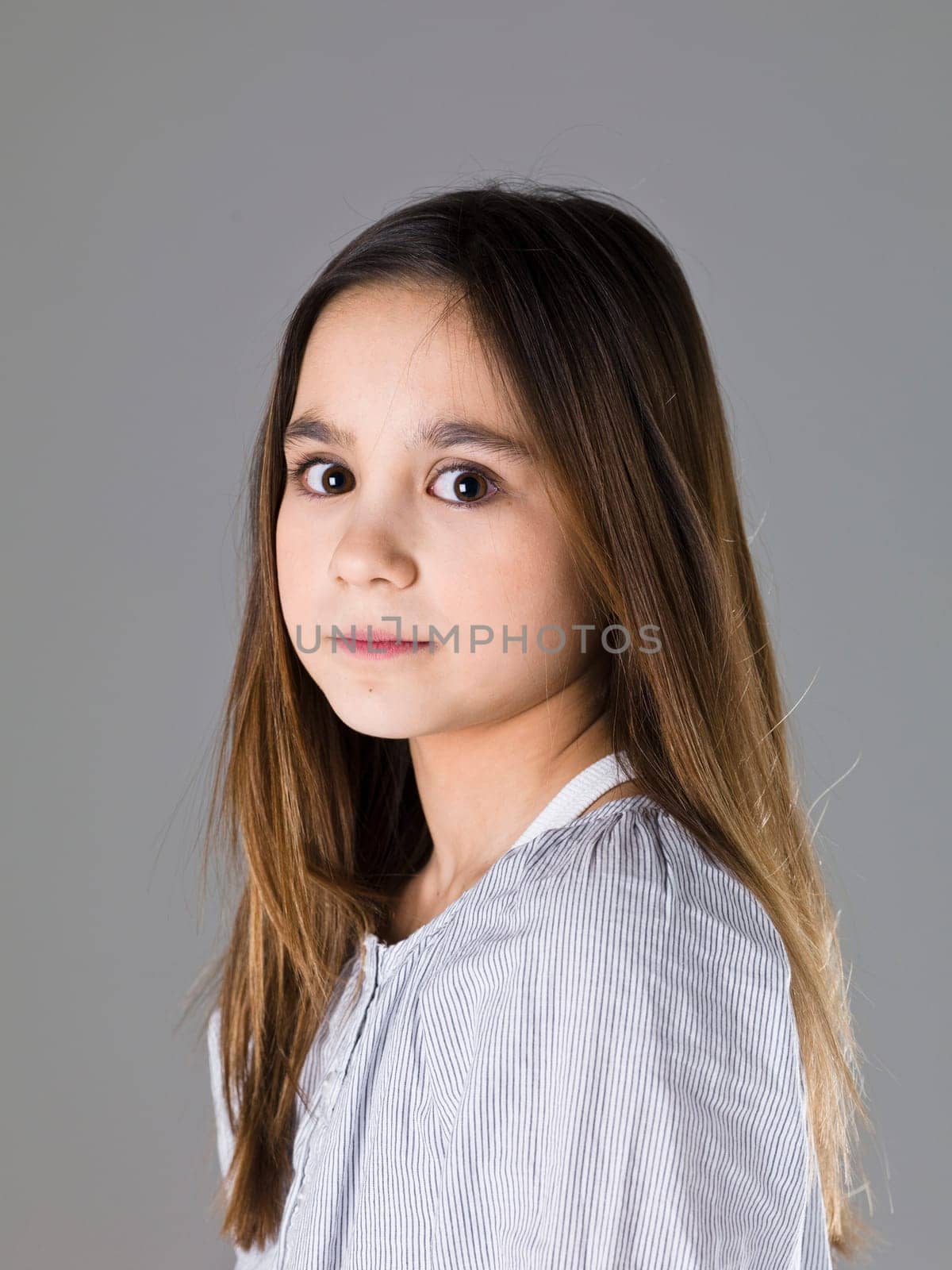 Portrait of a young girl on grey background