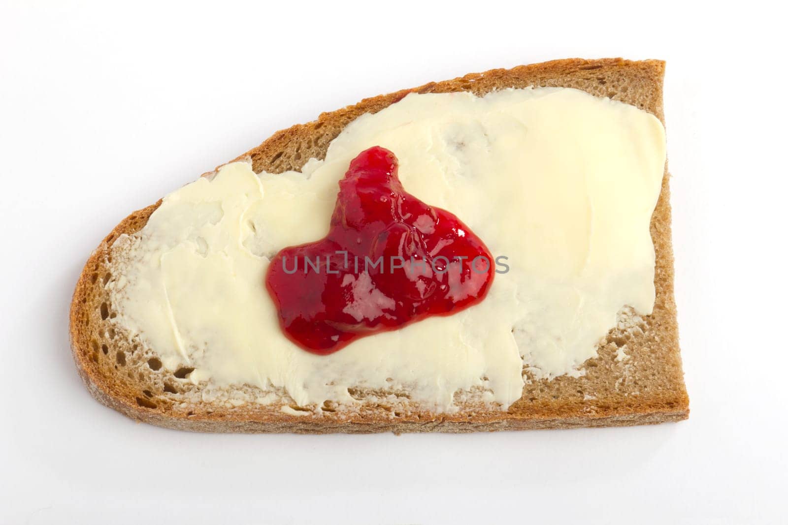 A slice of farmhouse bread with jam and butter