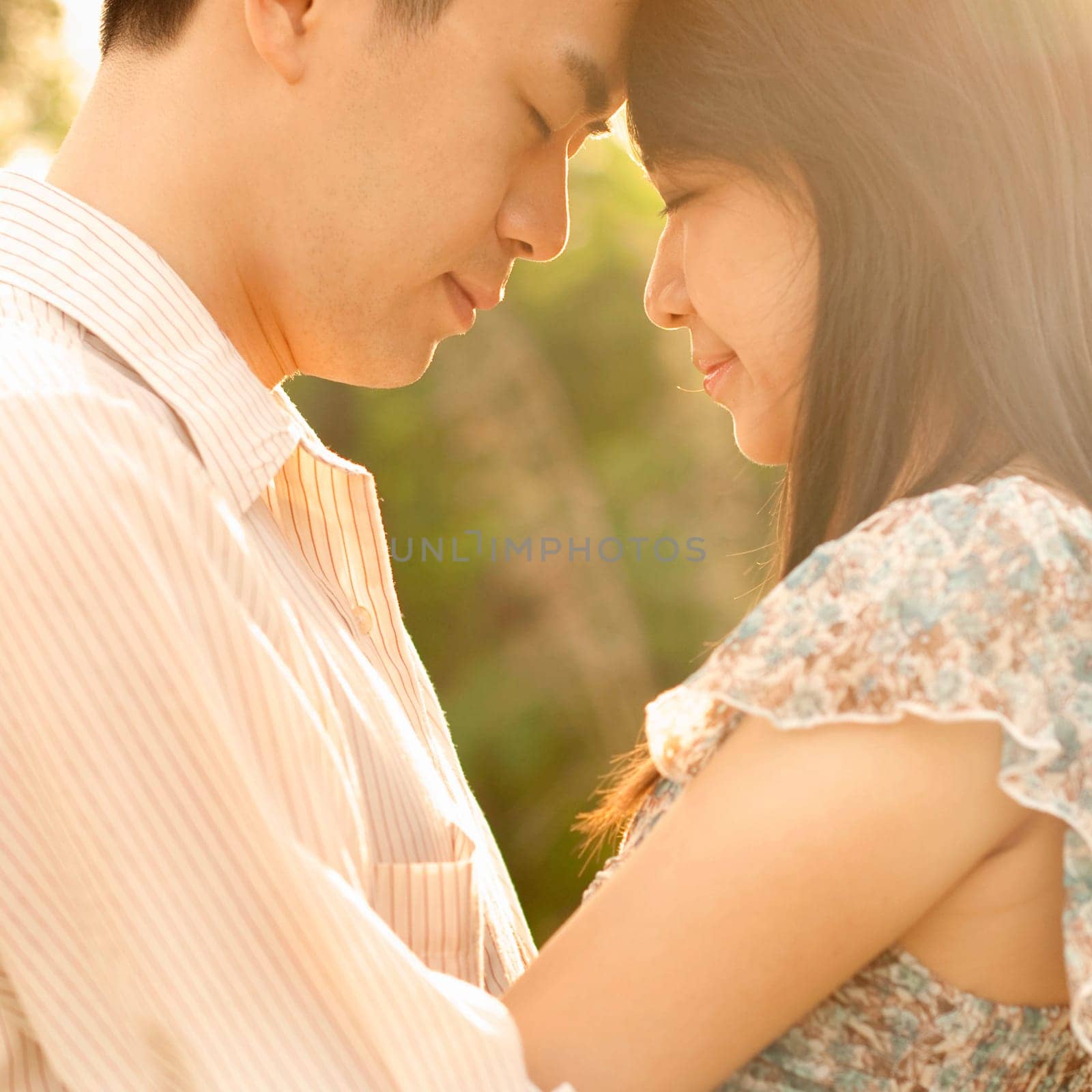 Asian couple enjoying in outdoor sunset