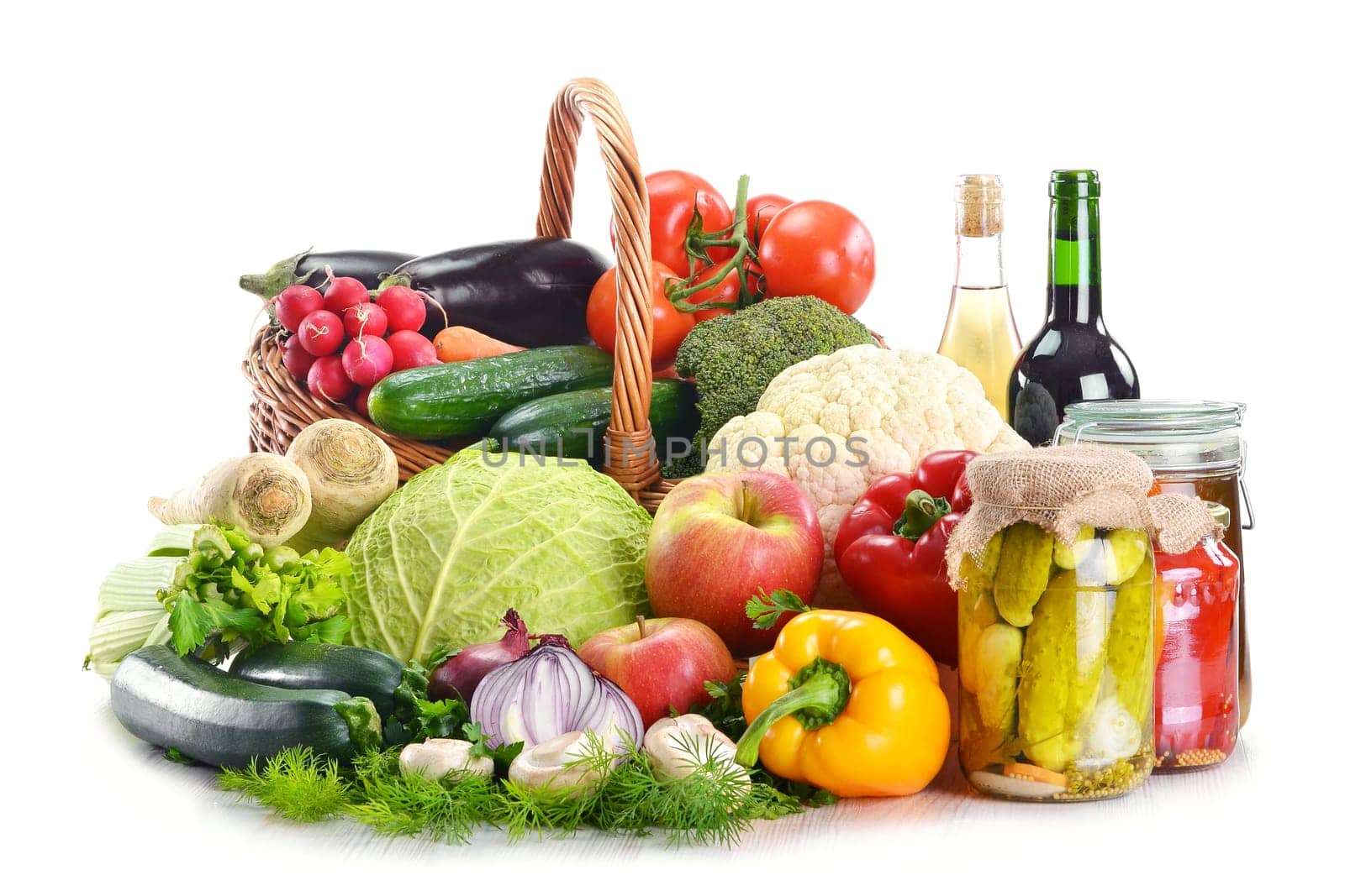 Composition with wicker basket and grocery isolated on white