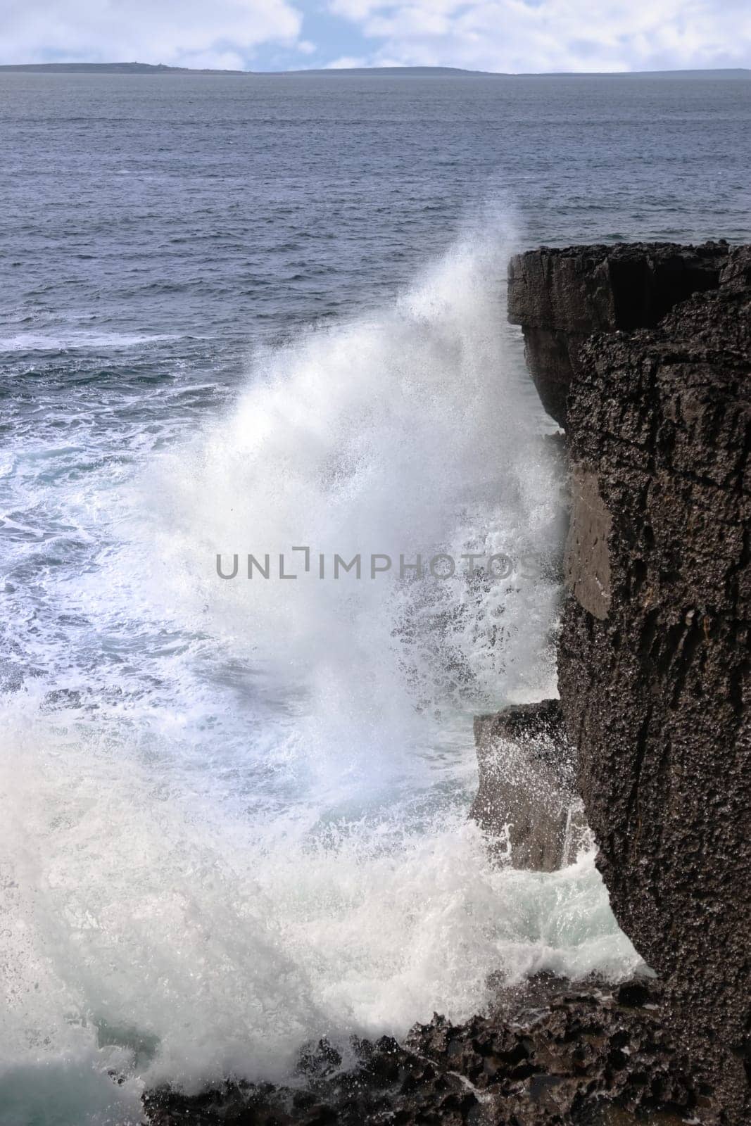 cliffs and coastline of the burren in county clare ireland with waves crashing on the rocks