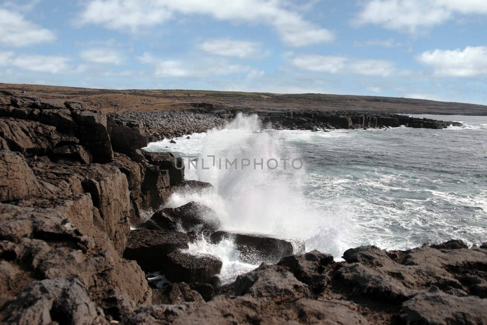 cliffs and coastline of the burren in county clare ireland with waves crashing on the rocks