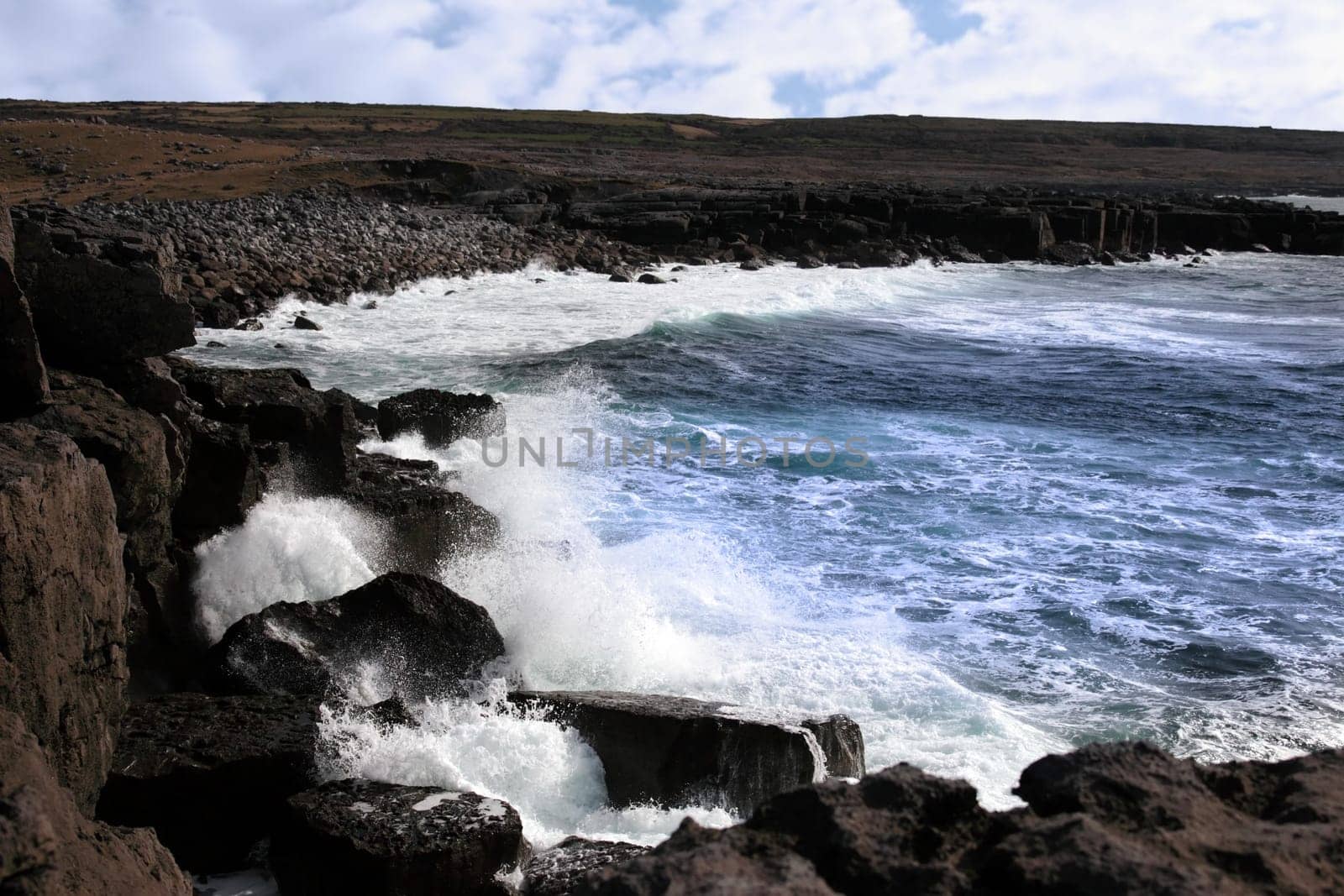 cliffs and coastline of the burren in county clare ireland with waves crashing on the rocks