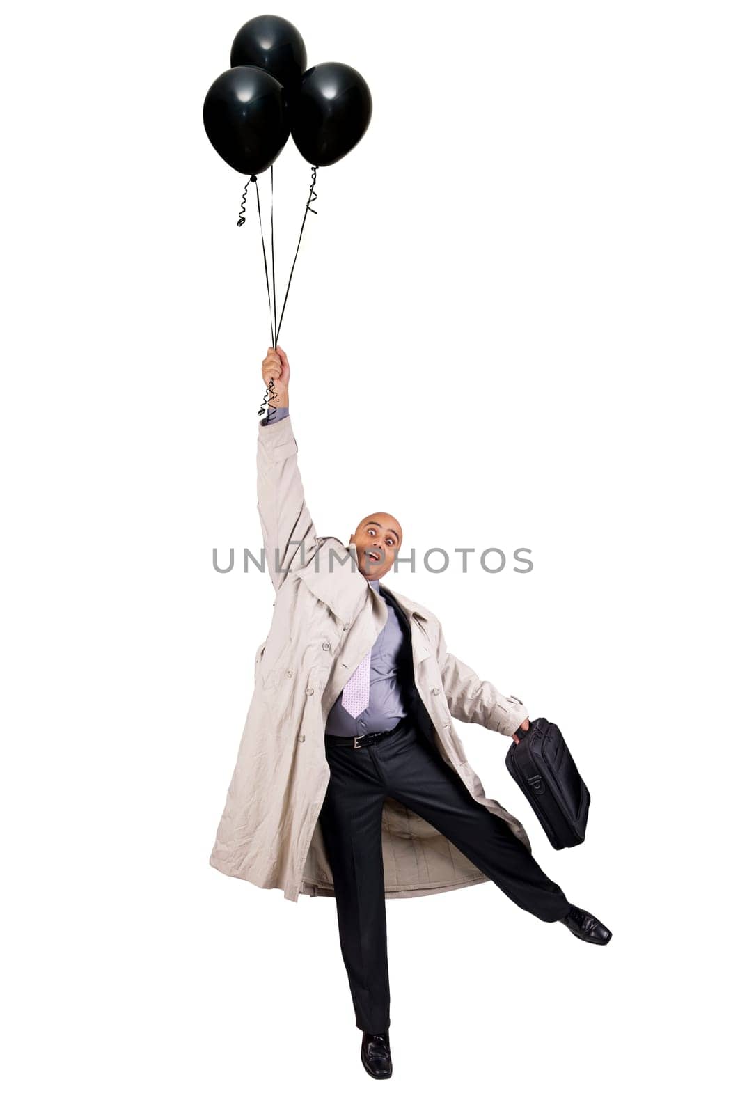 Businessman holding a group of black balloons