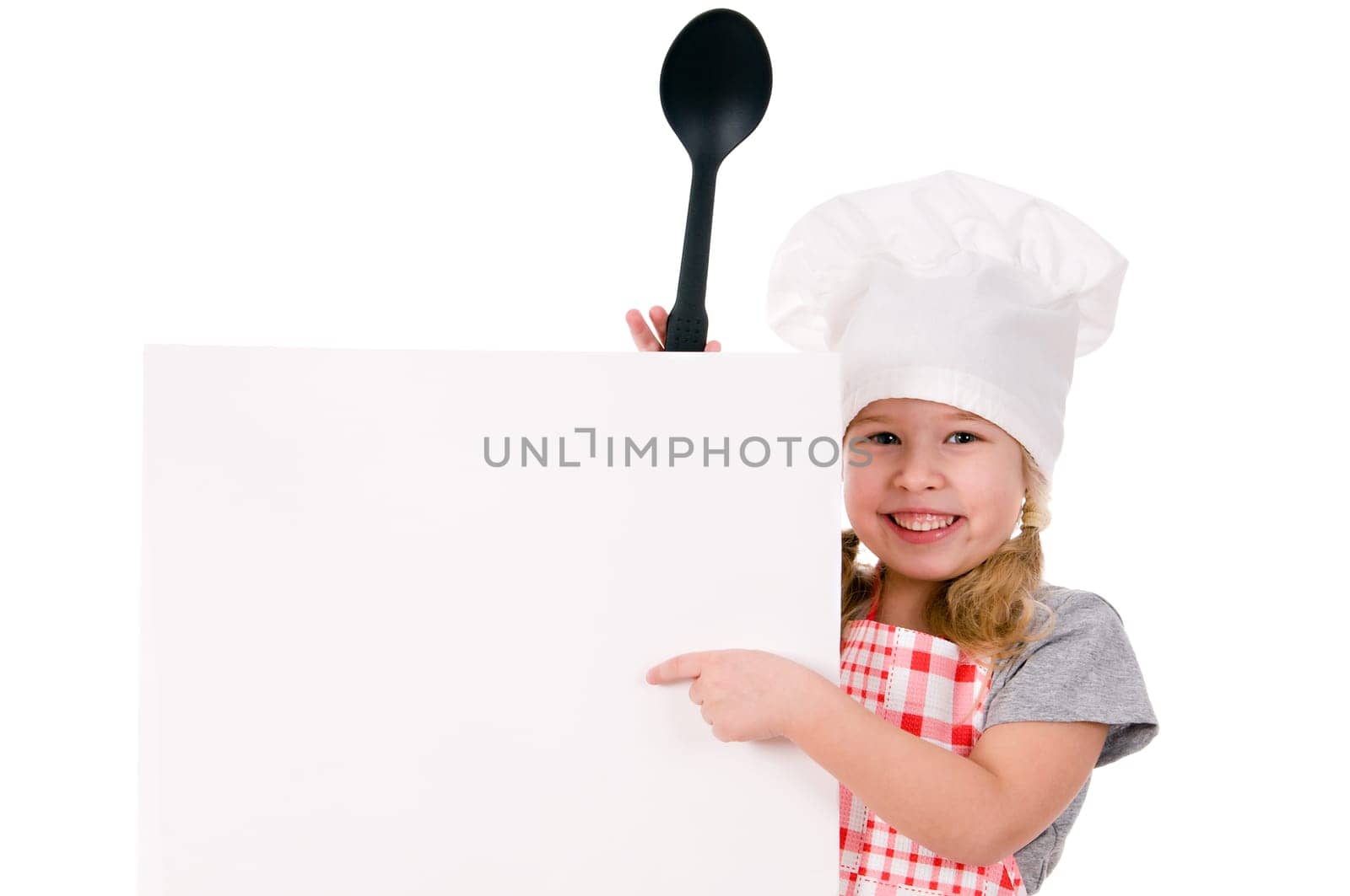 girl in chef&#039 s hat indicates on blank sheet isolated on white background