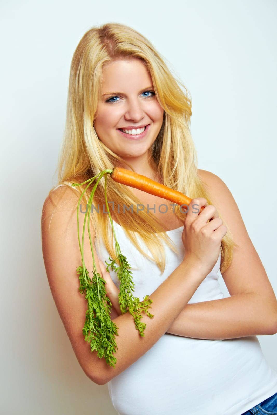 Young healthy woman with carrot