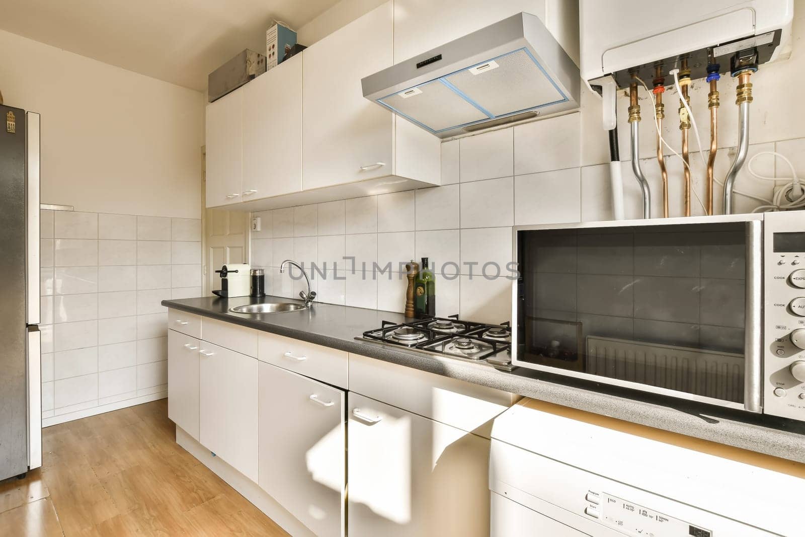 a kitchen with an oven, microwave and dishwasher in the photo is taken from the front view window