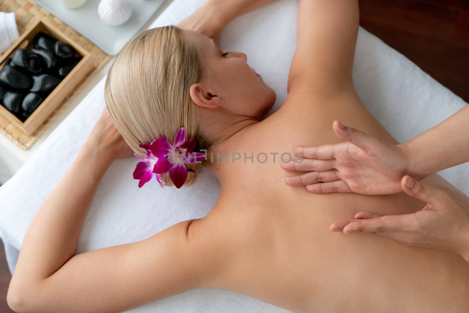 Caucasian woman customer enjoying relaxing anti-stress massage. Quiescent by biancoblue