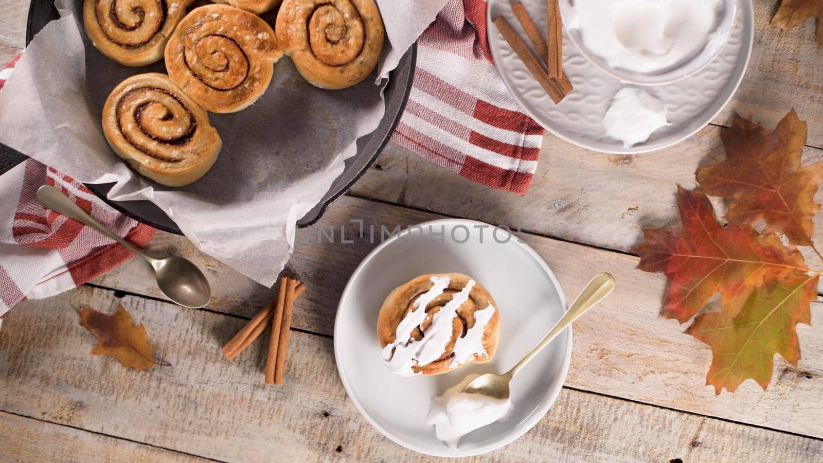 Cinnamon buns with chocolate chips baked in a cast iron pan.