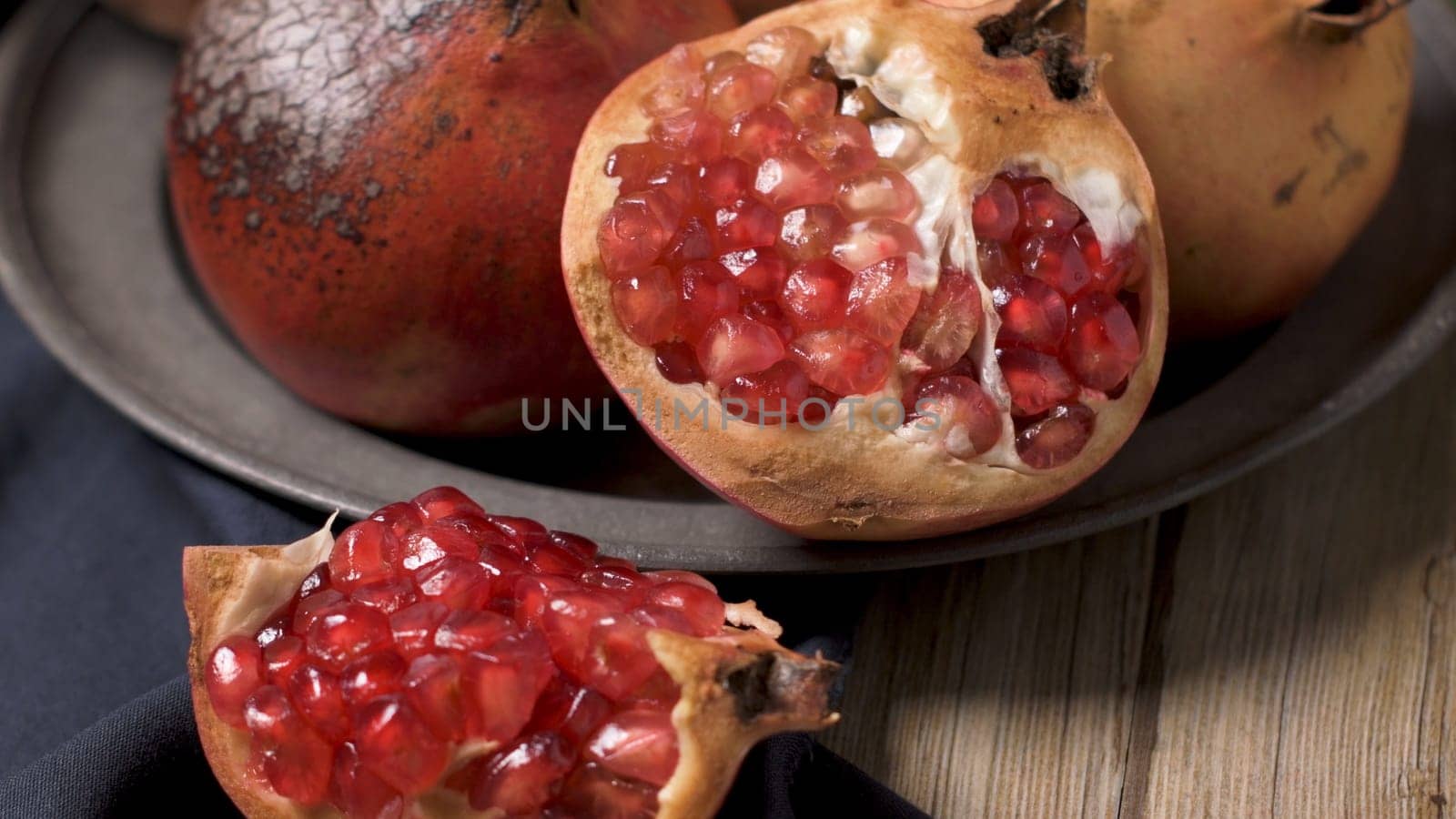 Pomegranate fruit on rustic table in vintage style.