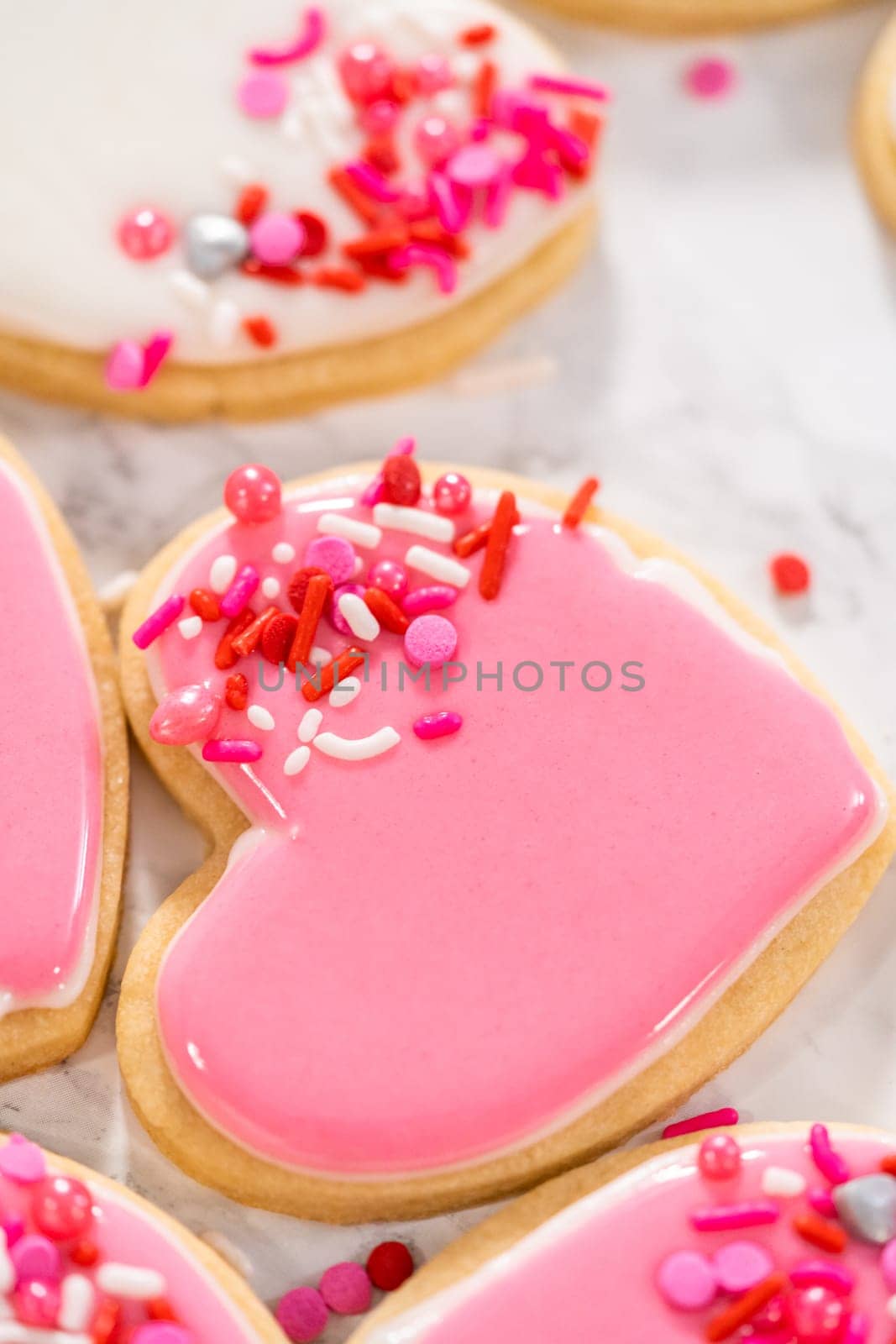 Heart-shaped sugar cookies with royal icing by arinahabich
