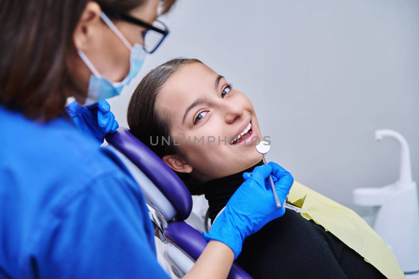 Young teenage female on dental examination treatment in clinic by VH-studio