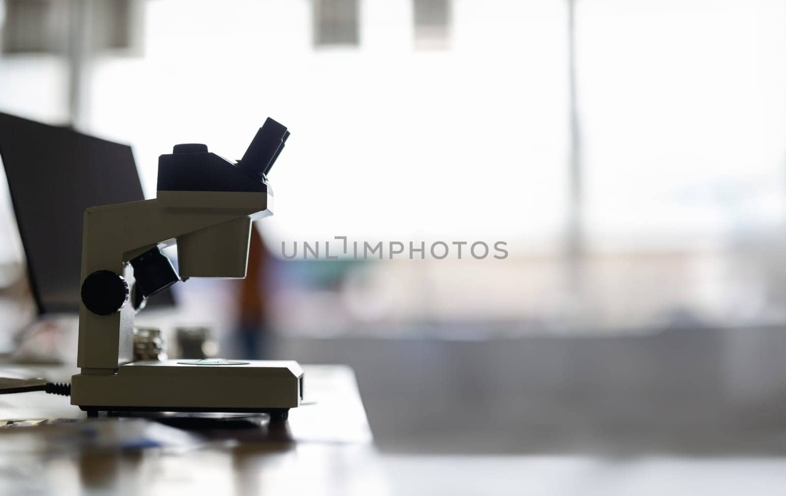 Microscope in a laboratory - on a white wall - empty space for text by Studia72