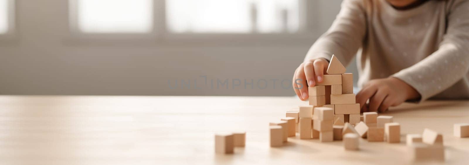 Kid playing with colorful wooden toy blocks. Little boy or girl building tower of block toys. Educational and creative toys and games for young children. Baby in white bedroom with rainbow bricks. Child at home. Copy space Space for text