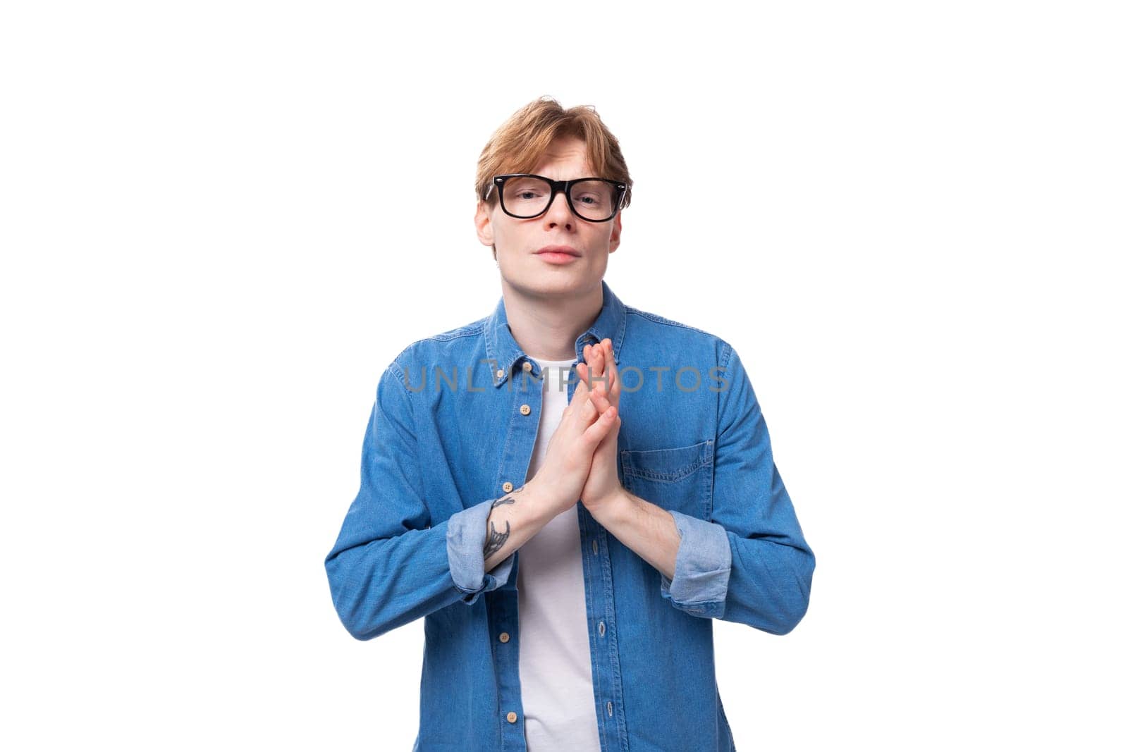 young smart european man with copper hair wears denim shirt is brainstorming.