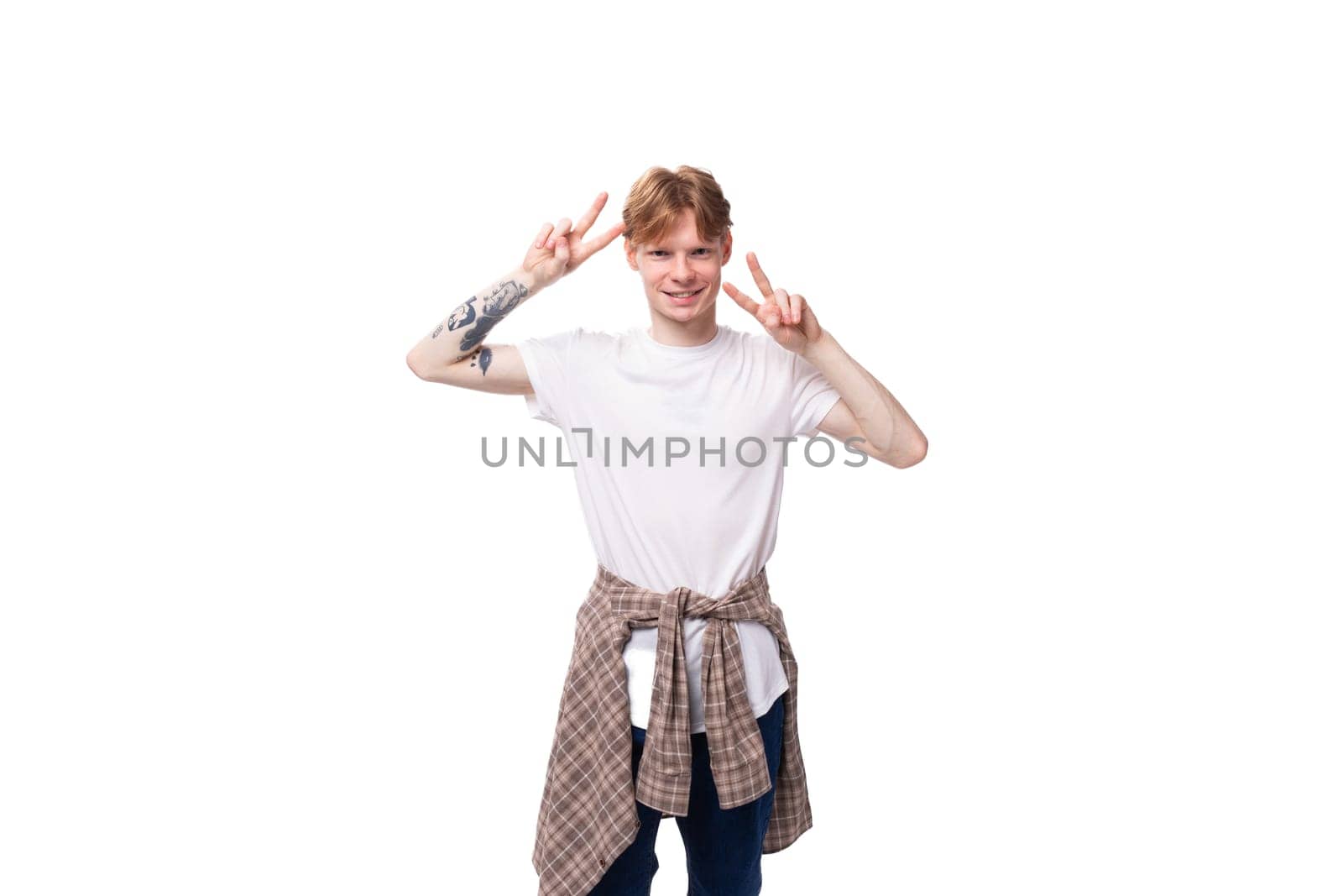 young cheerful positive european male student with golden red hair wearing glasses on white background.